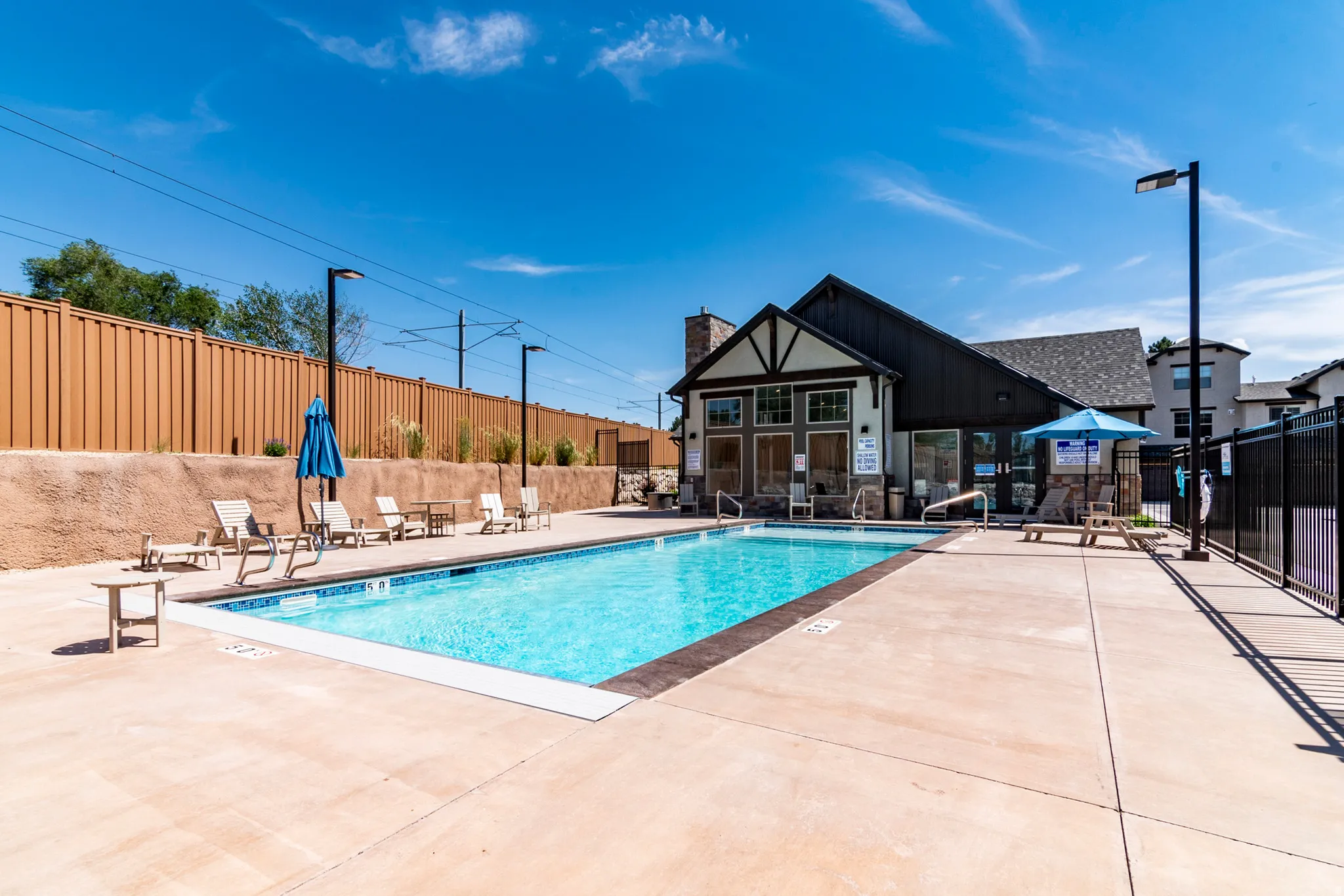Outdoor swimming pool with integrated steps, surrounded by a concrete deck