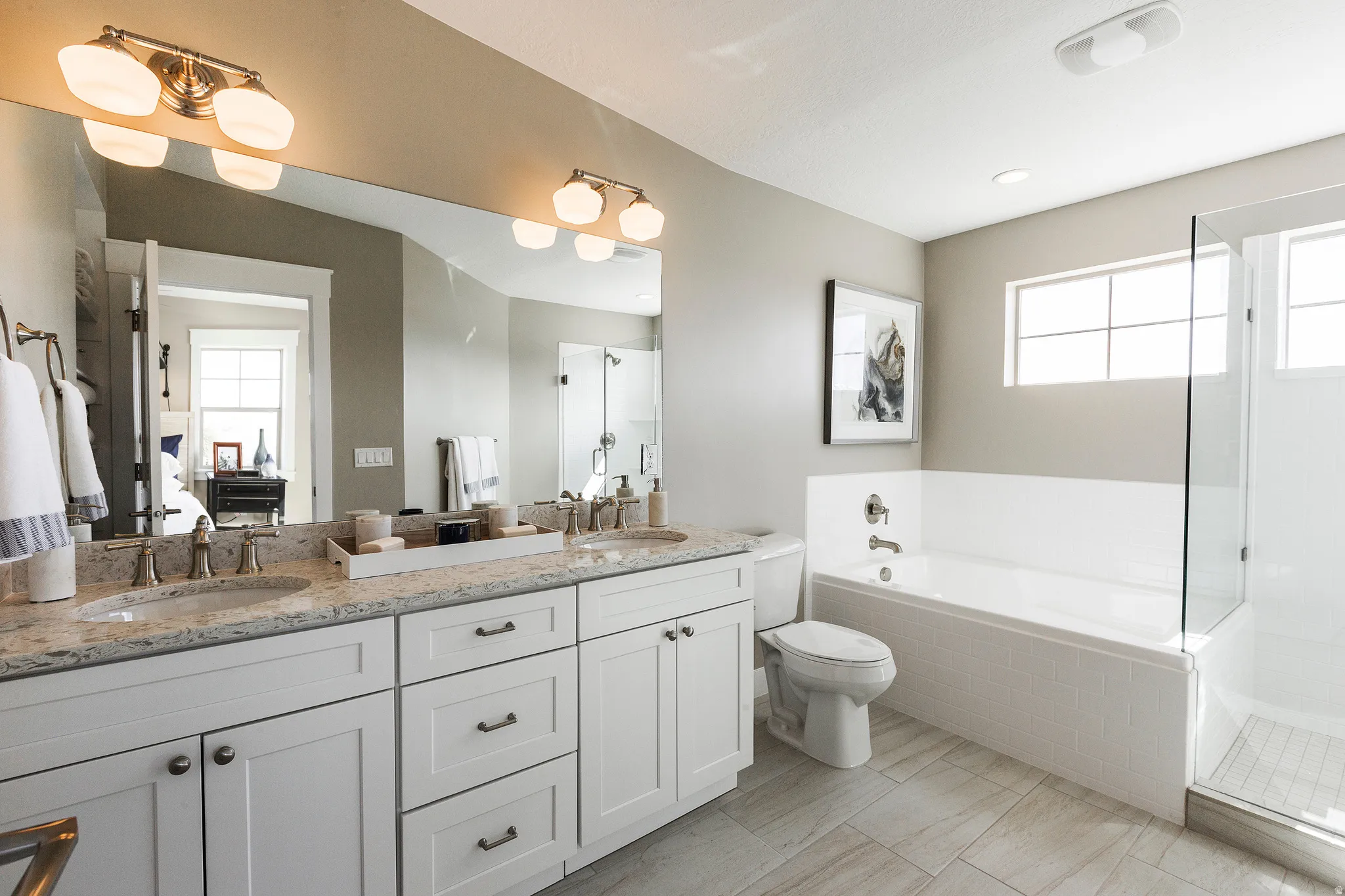 Primary Bath, Dual vanity with light-toned countertop, undermount sinks, and brushed nickel fixtures