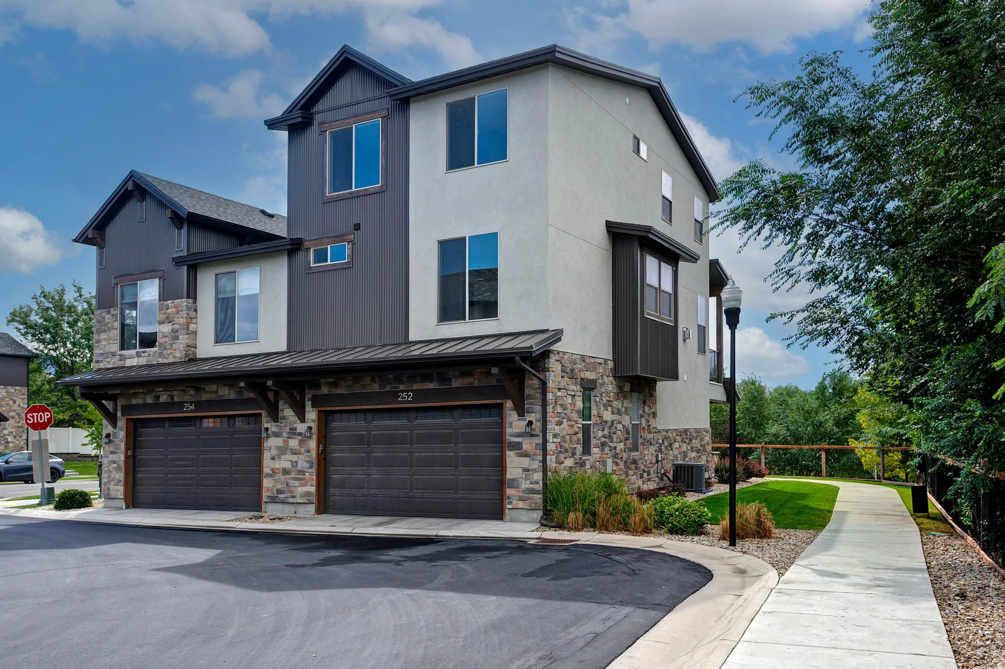 Multi-level exterior with stone and stucco finishes
