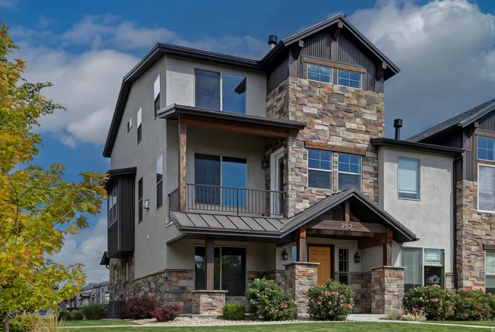 Stucco exterior with stone accents and dark trim