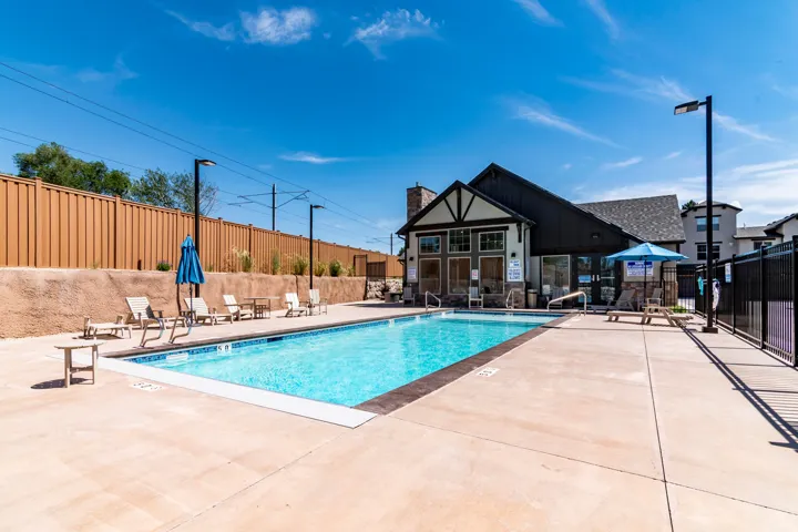 Outdoor swimming pool with integrated steps, surrounded by a concrete deck