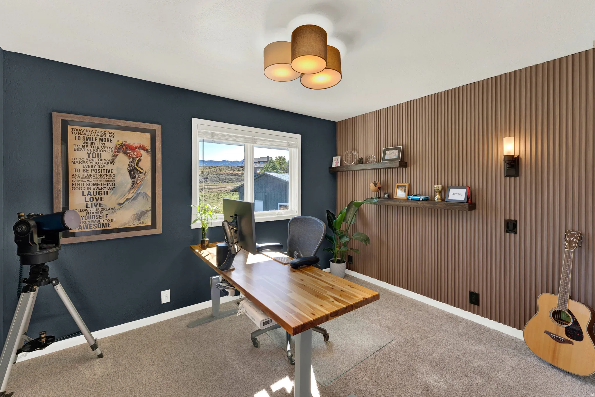 Textured wall paneling, built-in floating shelves, and an overhead drum-shade light fixture