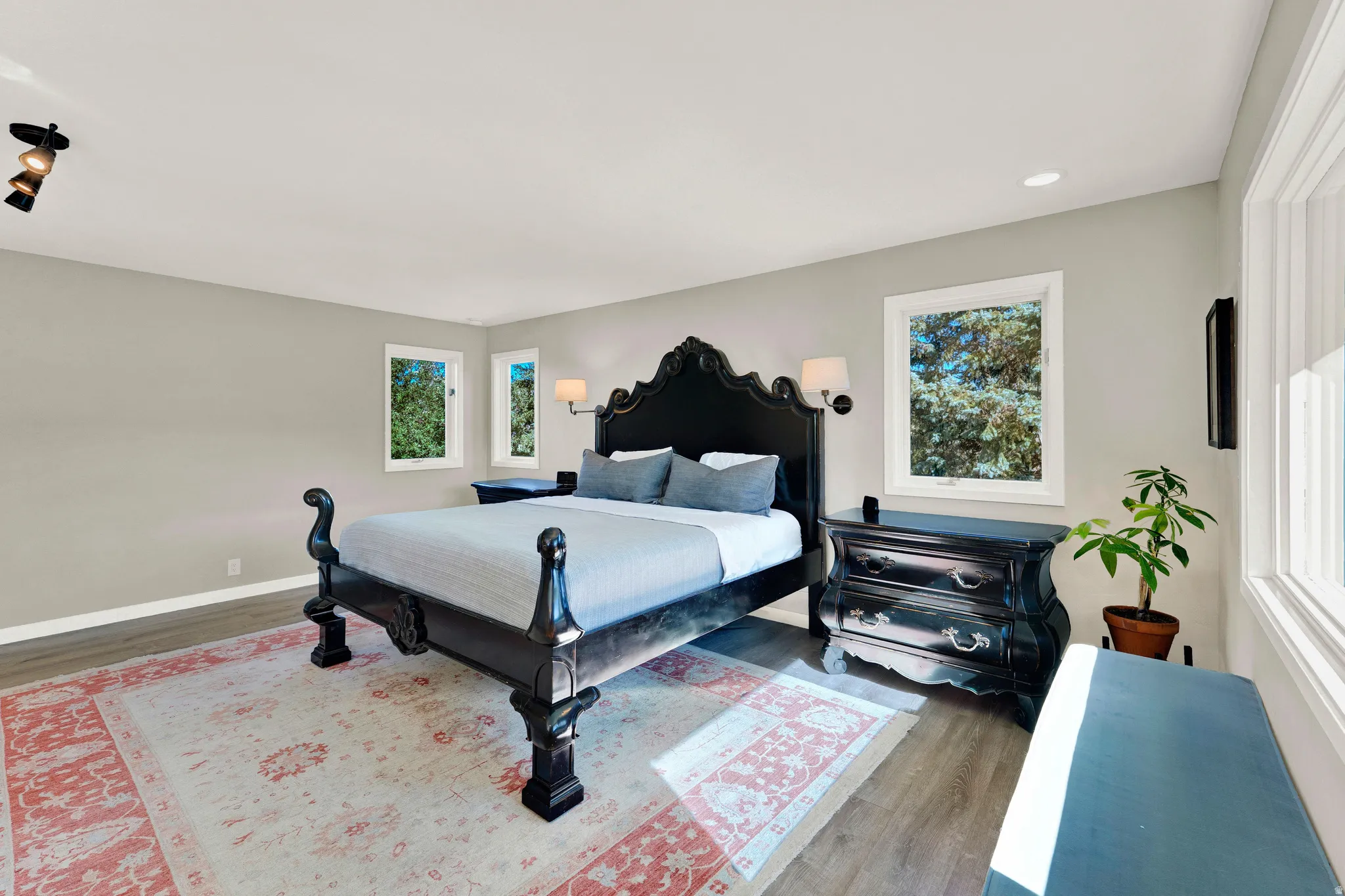 Recessed lighting, track lighting, and multiple windows with white trim