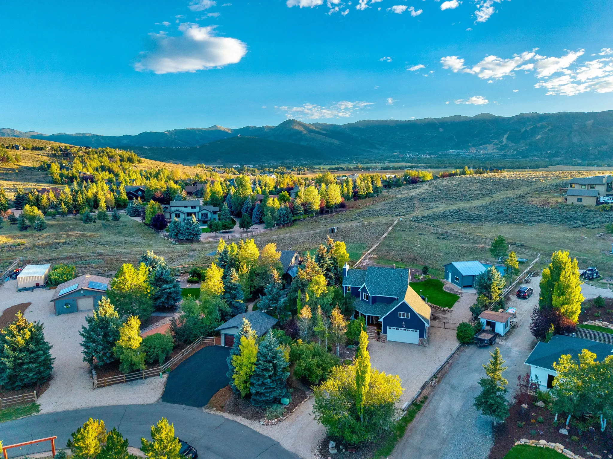 Mountainous landscape with expansive properties, mature trees, and natural terrain