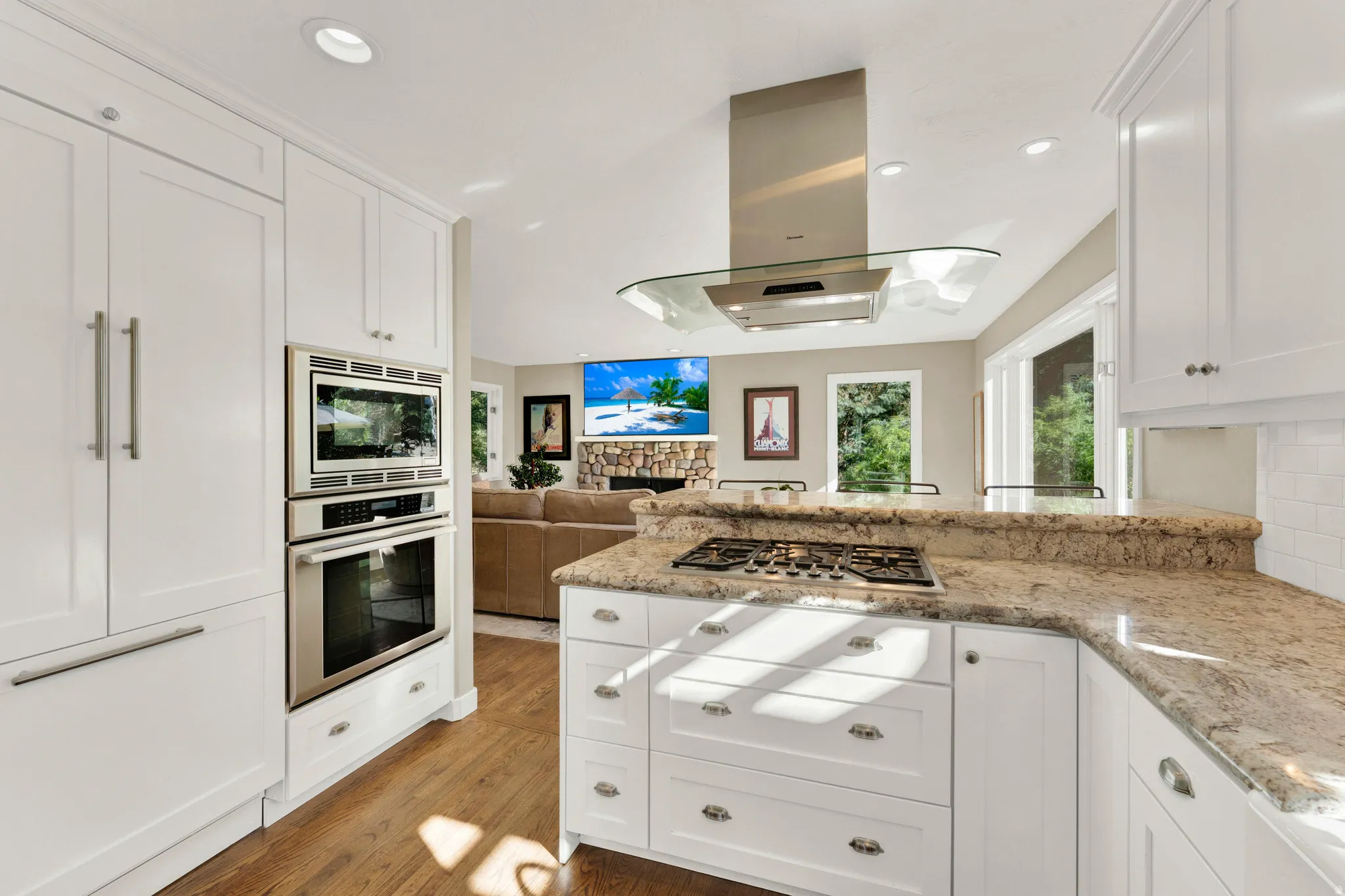 Kitchen featuring white cabinetry, built-in stainless steel appliances, a gas cooktop, and granite countertops