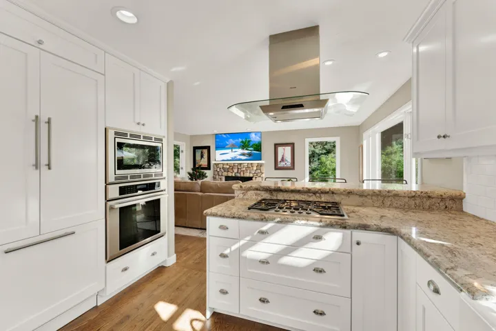 Kitchen featuring white cabinetry, built-in stainless steel appliances, a gas cooktop, and granite countertops