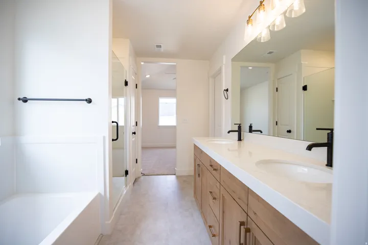Primary bathroom with separate tub and shower and double vanity