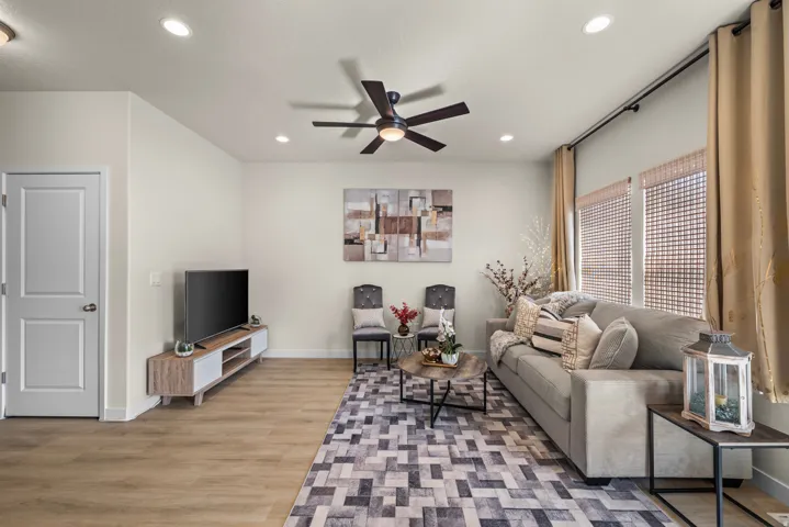 Recessed lighting, wood-finish flooring, ceiling fan, and multiple windows with blinds