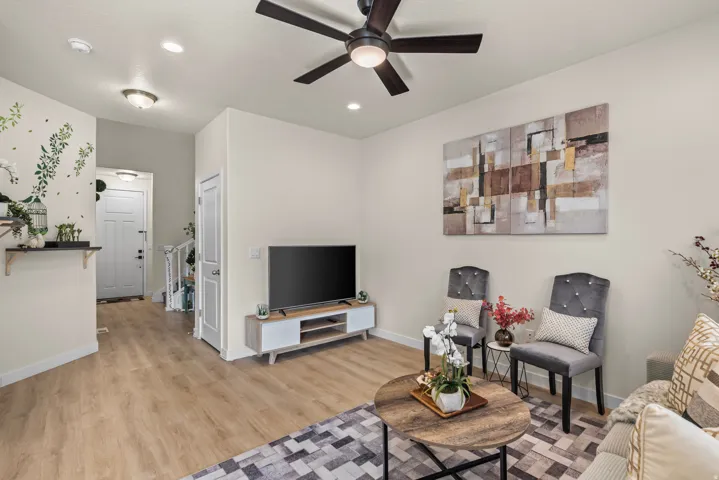Recessed lighting, wood-finish flooring, and a ceiling fan with integrated lighting