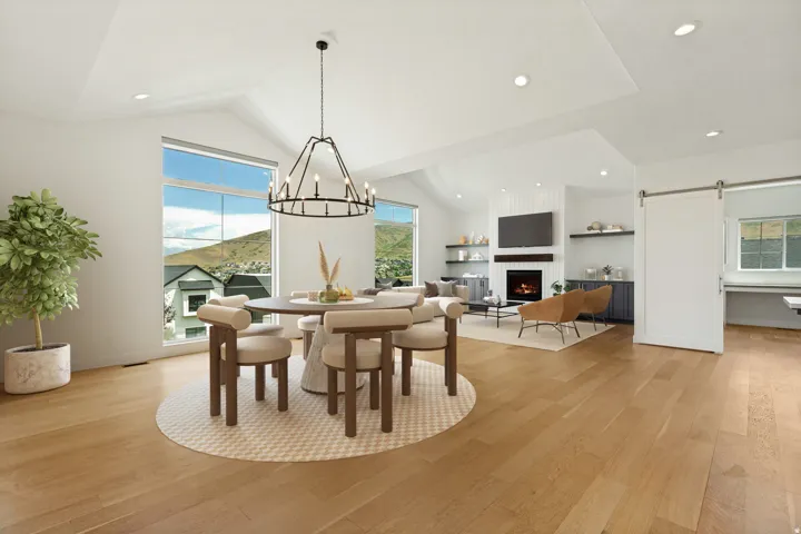 Vaulted ceilings, wood-finish flooring, recessed lighting, built-in fireplace, and a sliding barn door