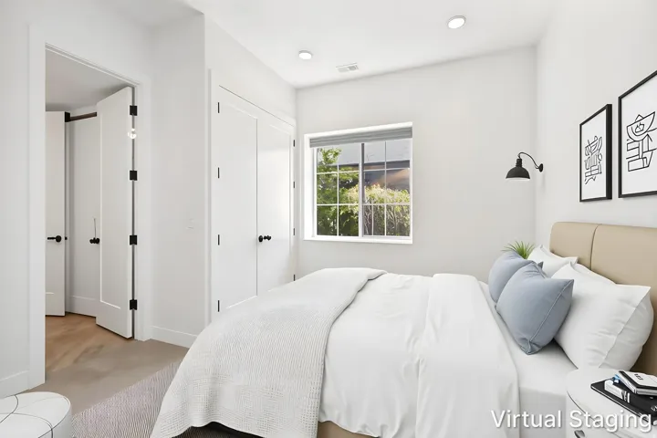 Recessed lighting, wood-finish flooring, and white paneled doors with matte black hardware