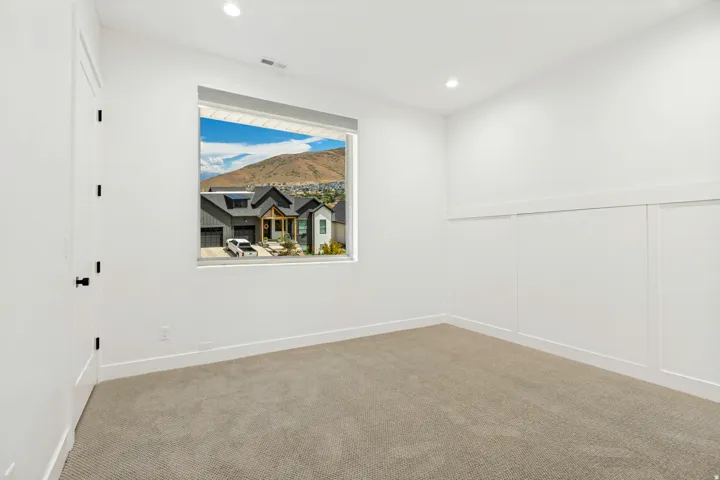 Recessed ceiling lighting, a large window, and board and batten wall detailing