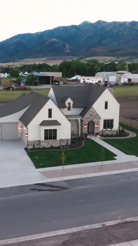 Stone and stucco exterior with dark trim windows