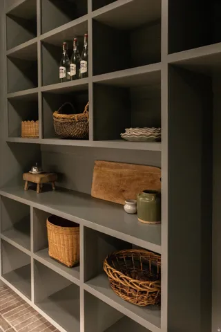 Built-in shelving unit with a dark gray finish