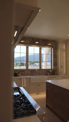 Gourmet kitchen with a built-in gas range, farmhouse sink, stone backsplash, and recessed lighting