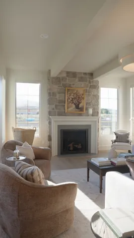 Stone-clad fireplace with mantel, recessed lighting, exposed ceiling beams, wood-finish flooring, and multiple windows