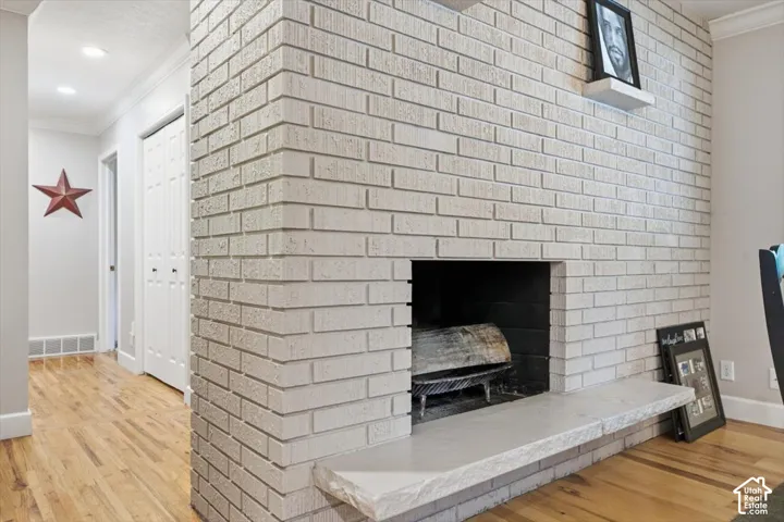 Brick-clad fireplace with a stone hearth, featuring a wood-burning insert