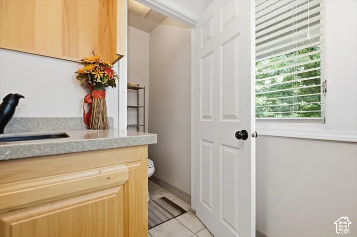 Light wood-finish cabinetry with a light-toned countertop
