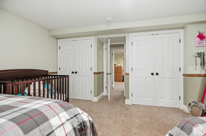 Plush carpeting, paneled interior doors with matte black hardware, and two-tone wall finishes