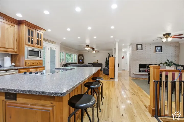 Kitchen featuring wood cabinetry, integrated microwave, and a cooktop