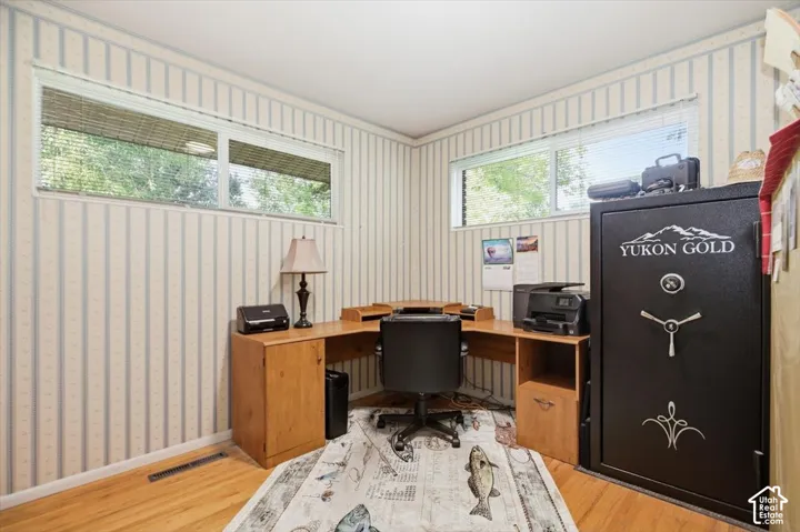 Light wood-finish flooring with striped wall covering