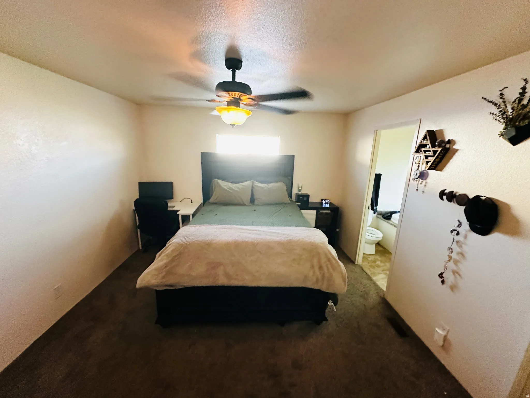 Recessed window opening, ceiling fan with light fixture, and carpet flooring