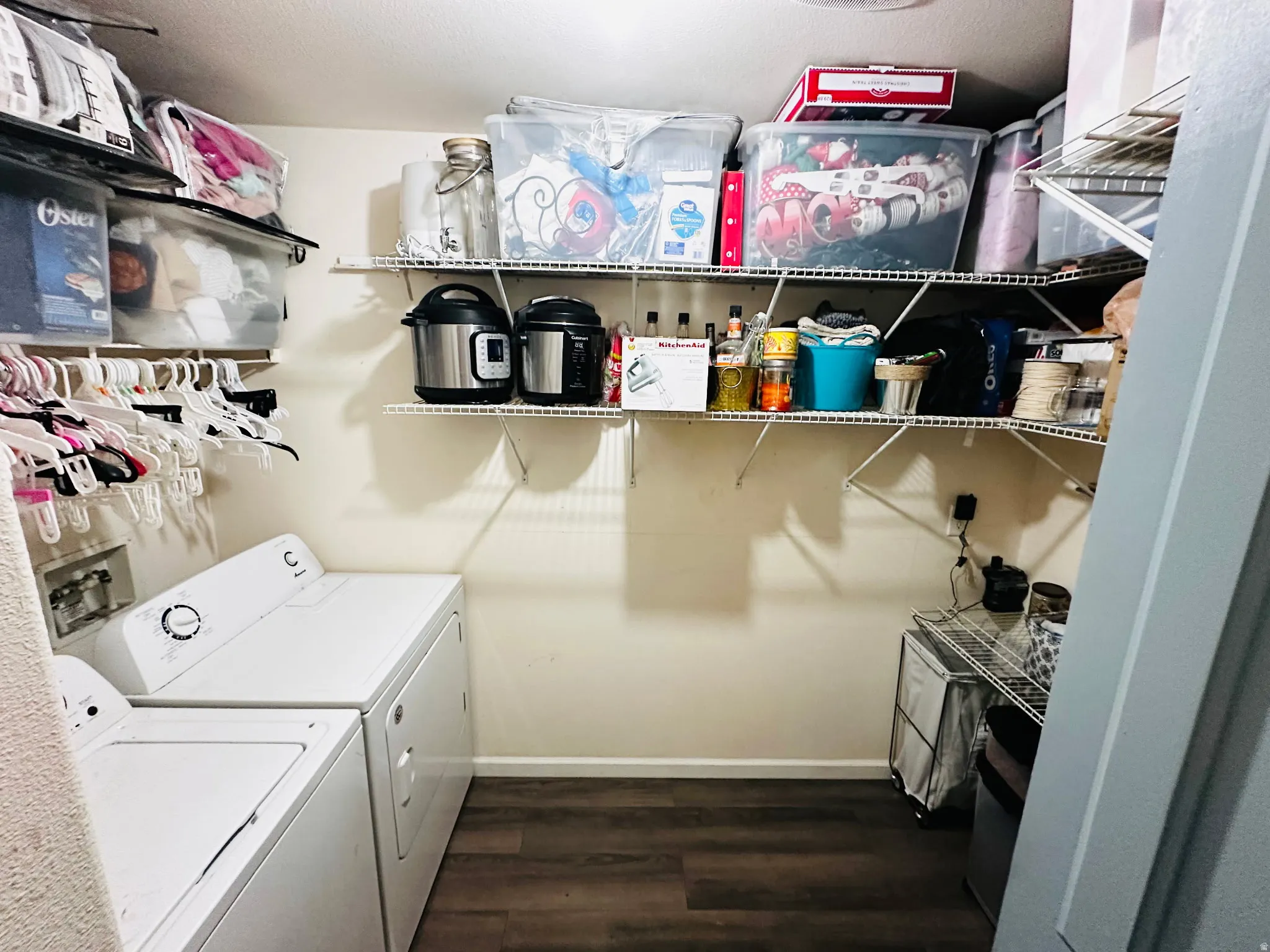 Laundry area featuring wood-finish flooring
