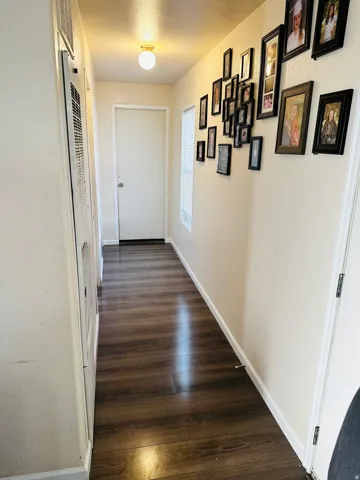 Wood-finish flooring throughout, complemented by a flush-mount ceiling light fixture