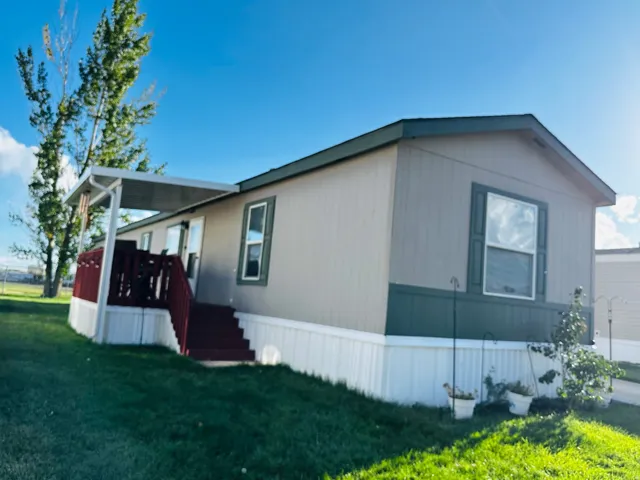 Exterior siding with contrasting trim, covered porch, and gabled roofline