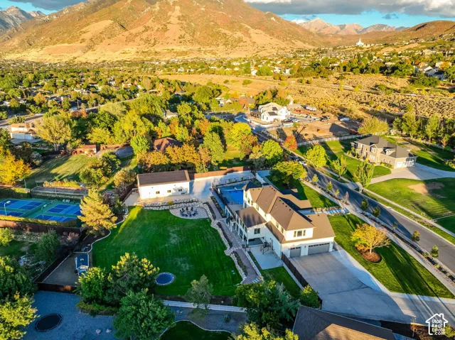 Expansive grounds featuring a swimming pool, multiple sports courts, and a manicured lawn