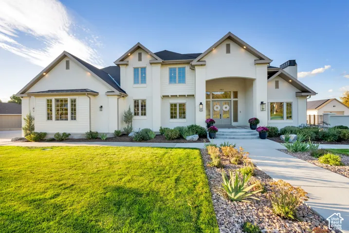 Stucco and board and batten exterior with a dark shingle roof