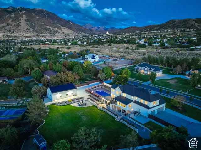Expansive property featuring a large residence, detached auxiliary building, swimming pool, and terraced landscaping