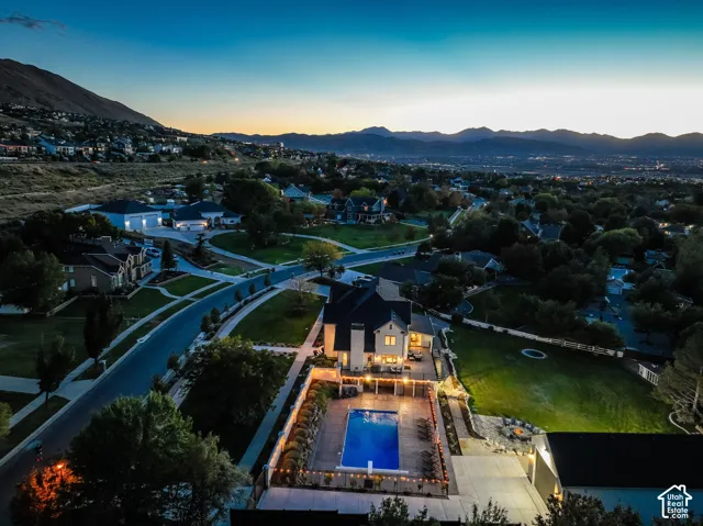Expansive property featuring a large in-ground swimming pool, a spacious patio area, and a significant lawn space