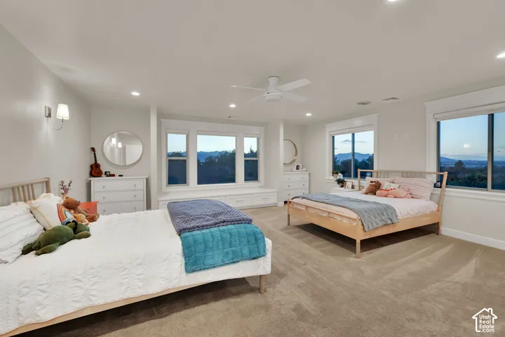 Large over the garage bedroom 2 queen beds.  Recessed lighting, ceiling fan, carpeting, built-in window seating, and multiple windows