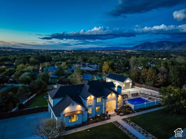 Expansive property featuring a large residence, detached auxiliary structure, swimming pool, and manicured landscaping