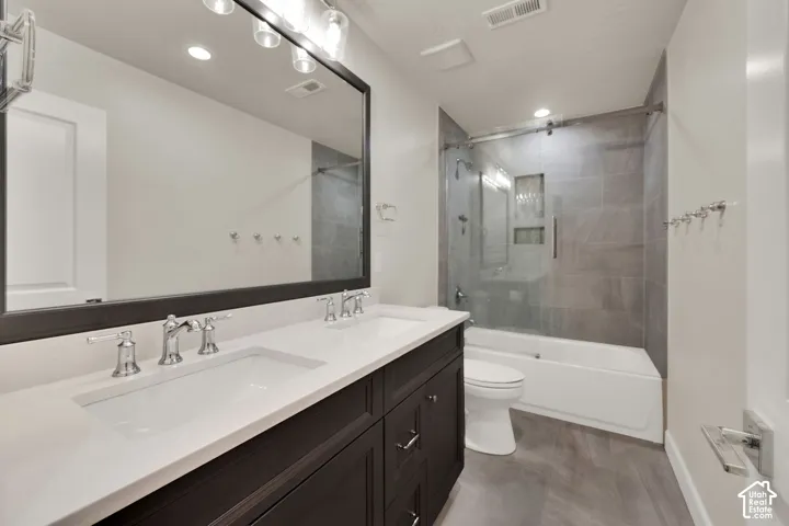 Bathroom 3 upstairs.  Dual sink vanity with dark wood-finish cabinetry and light-toned countertops