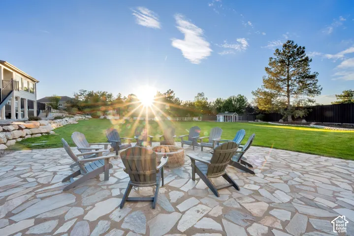 Expansive patio with flagstone paving and a built-in fire pit