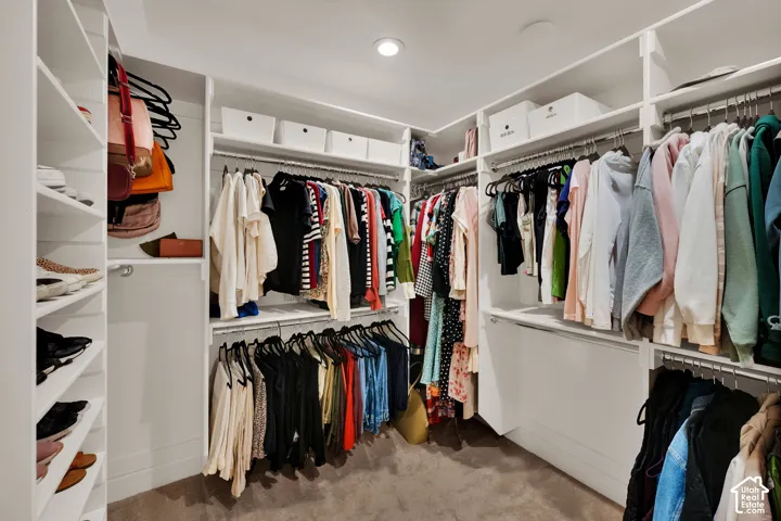 Primary Walk in Closet.  Built-in custom shelving, recessed lighting, and multiple hanging rods