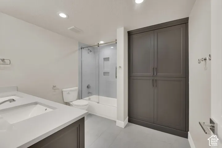 Basement bathroom.  Double vanity with integrated sinks and a light-toned countertop
