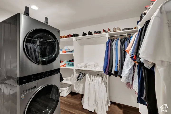 Basement bedroom with walk in closet and laundry.  Integrated laundry appliances and custom built-in closet organization system