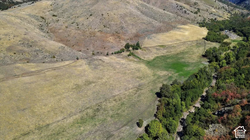 Expansive natural landscape featuring rolling hills and varied terrain