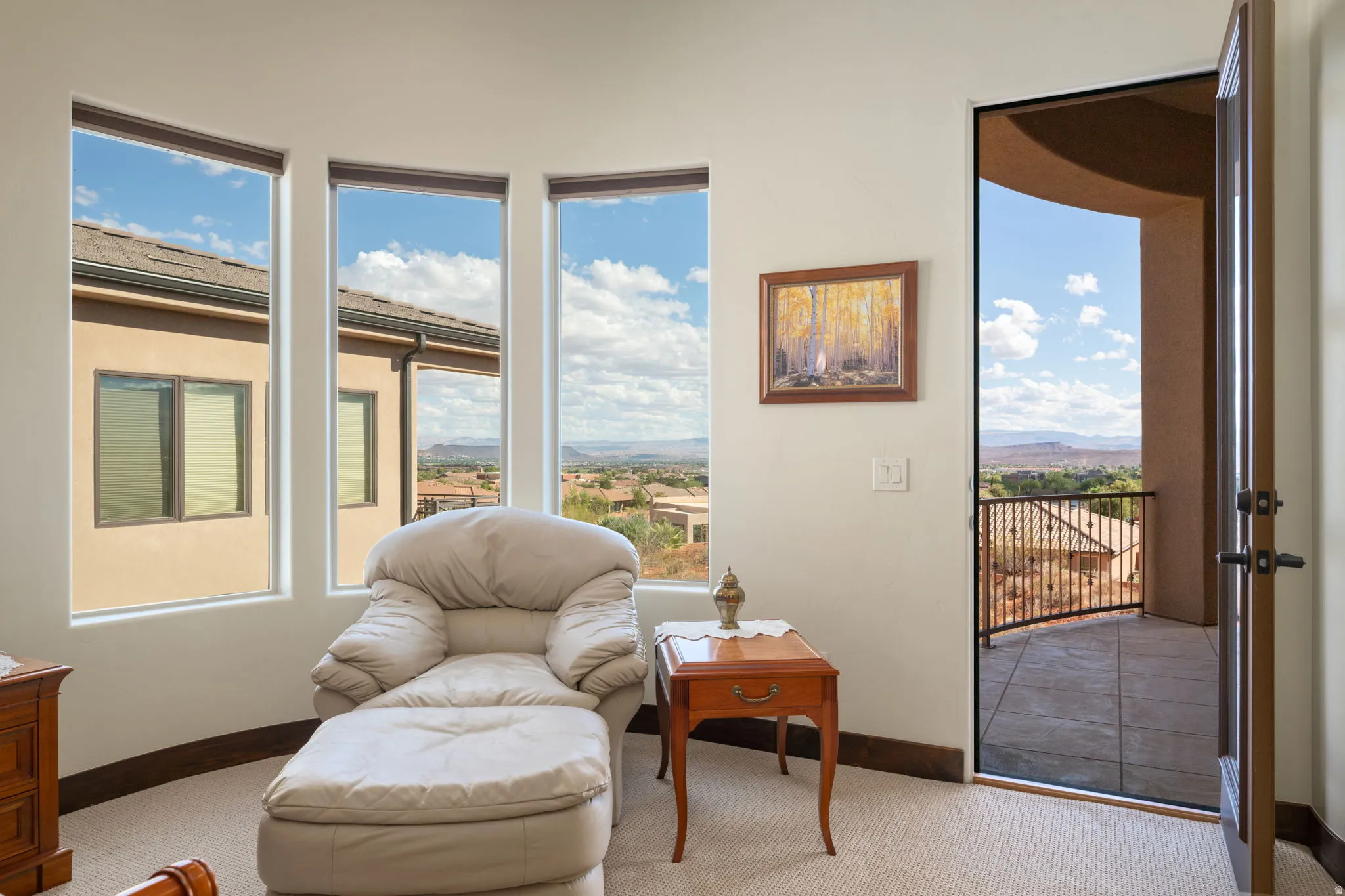 Primary Bedroom, Curved wall with three tall windows, a single exterior door, and a tiled balcony with a metal railing