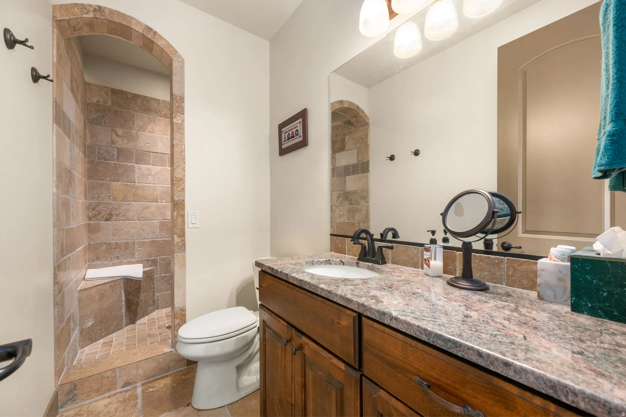 Arched, tiled shower with a built-in bench