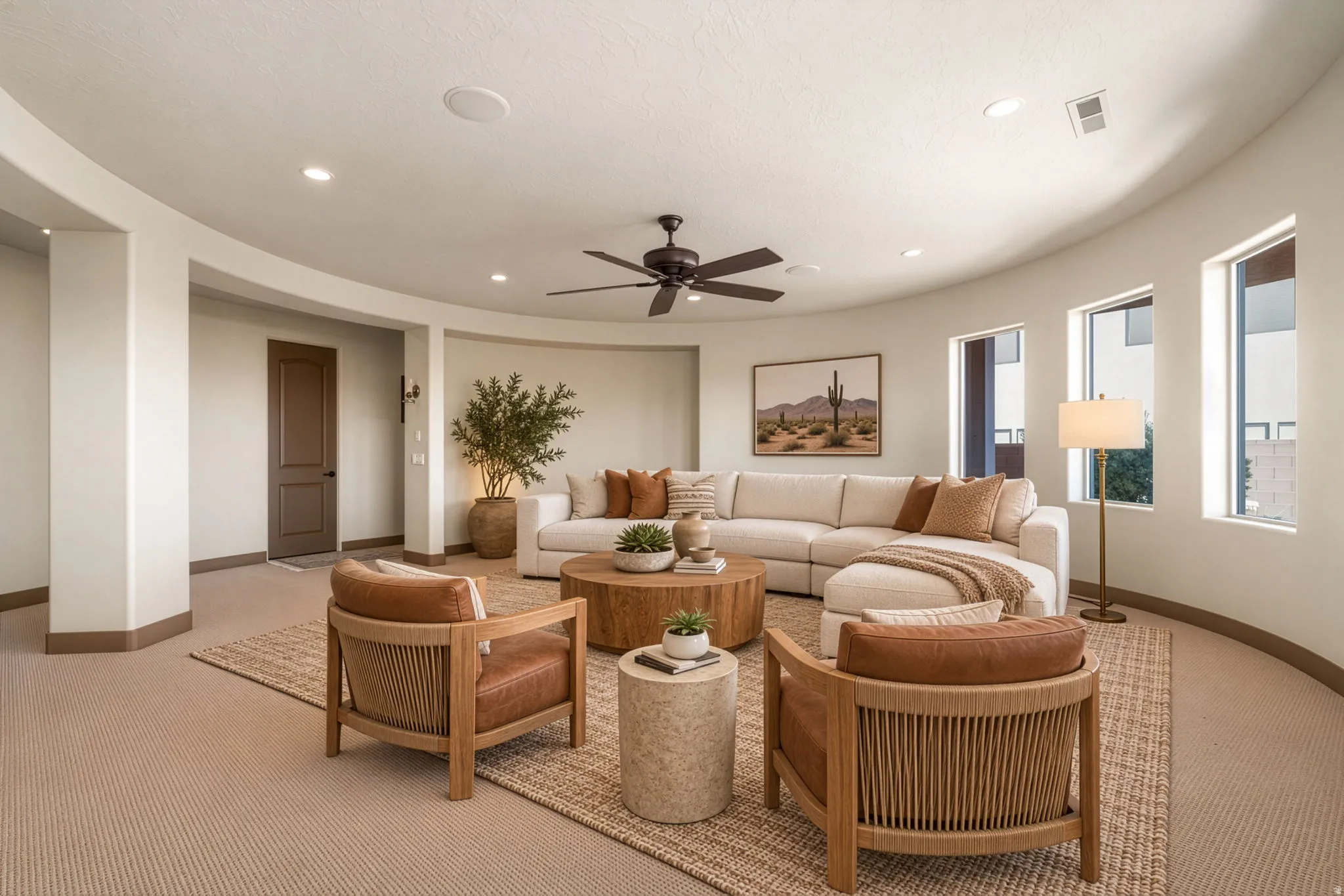 Curved architectural wall, recessed lighting, ceiling fan, multiple large windows, and neutral carpeting