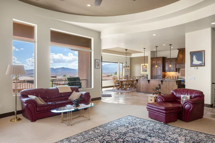 Open concept living area with high ceilings, recessed lighting, and large windows