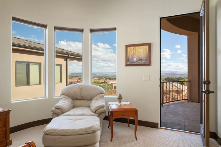 Primary Bedroom, Curved wall with three tall windows, a single exterior door, and a tiled balcony with a metal railing