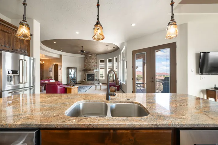 Kitchen island with double basin sink and a high-arc faucet