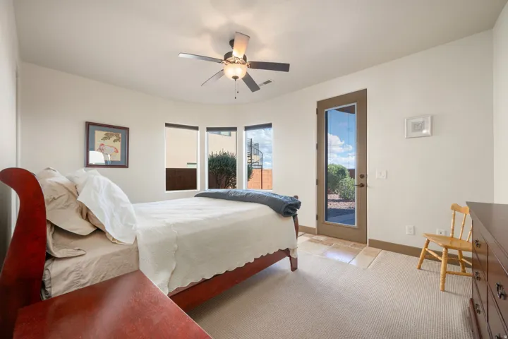 Recessed ceiling fan, carpeted flooring, bay windows, exterior access door, and tile flooring
