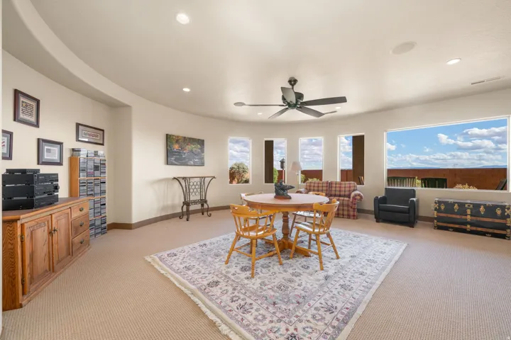 Curved wall architecture featuring recessed lighting and a ceiling fan