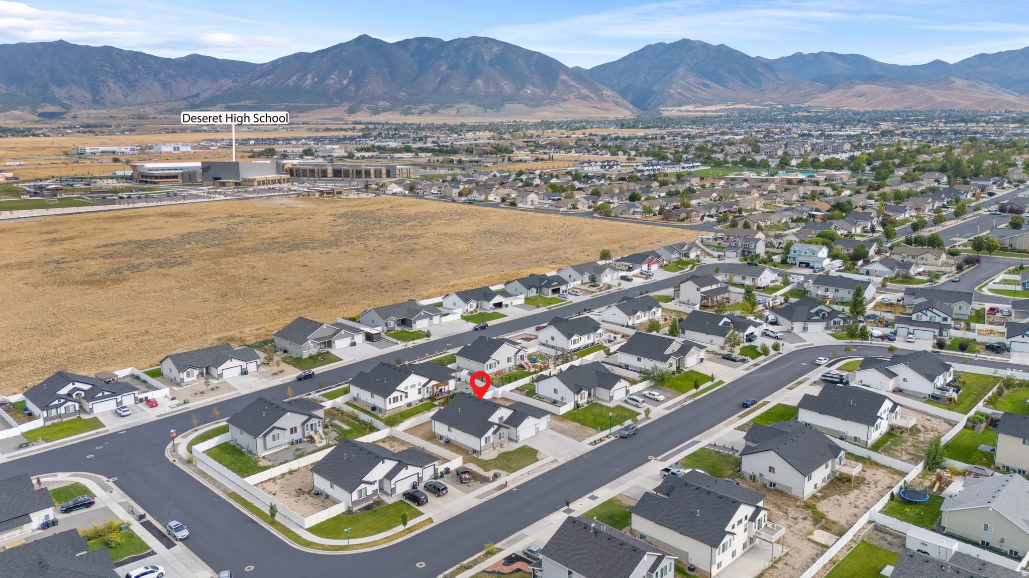 Aerial perspective showcasing a residential neighborhood with surrounding mountains